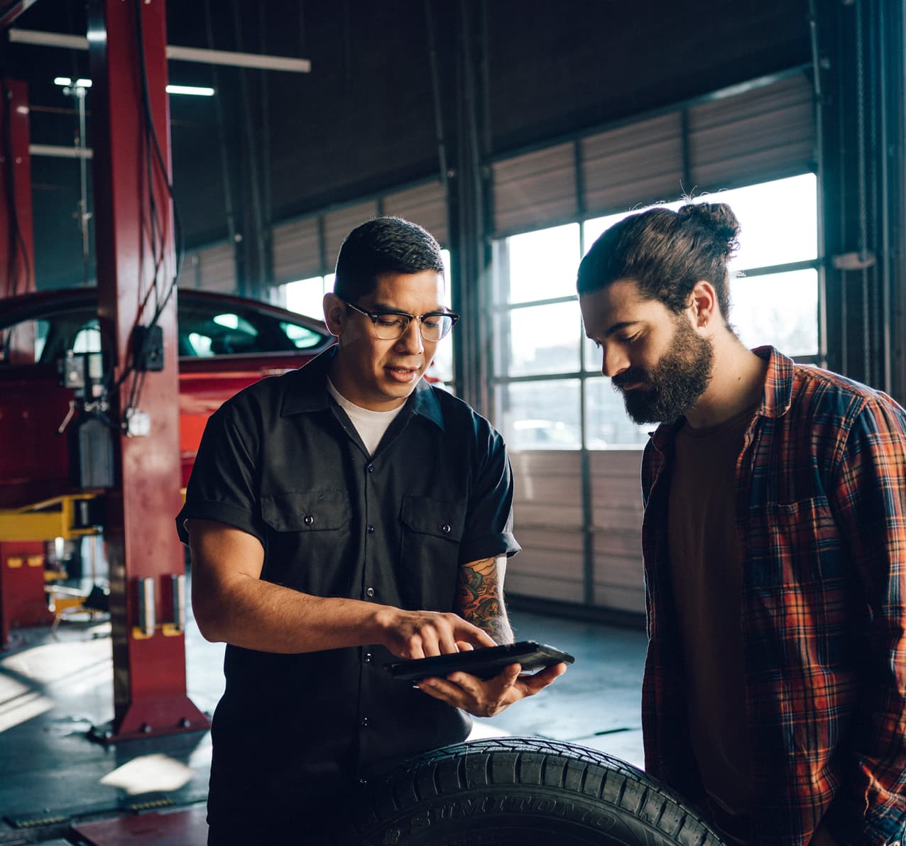 Two men in an auto body shop