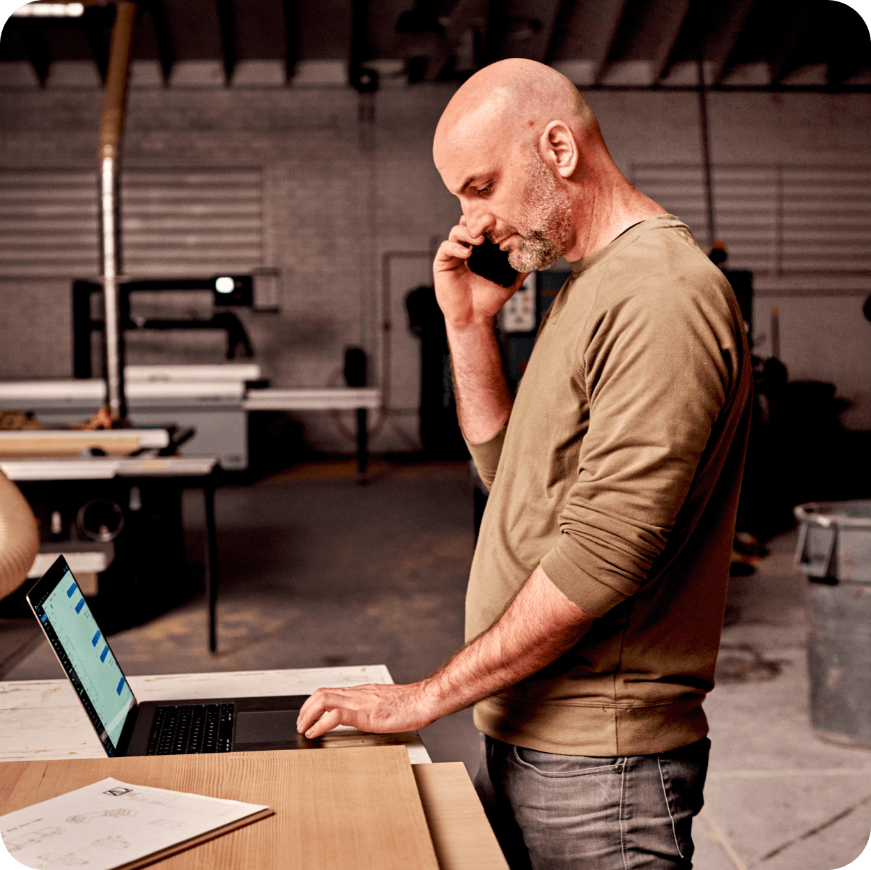A wood shop worker on the phone